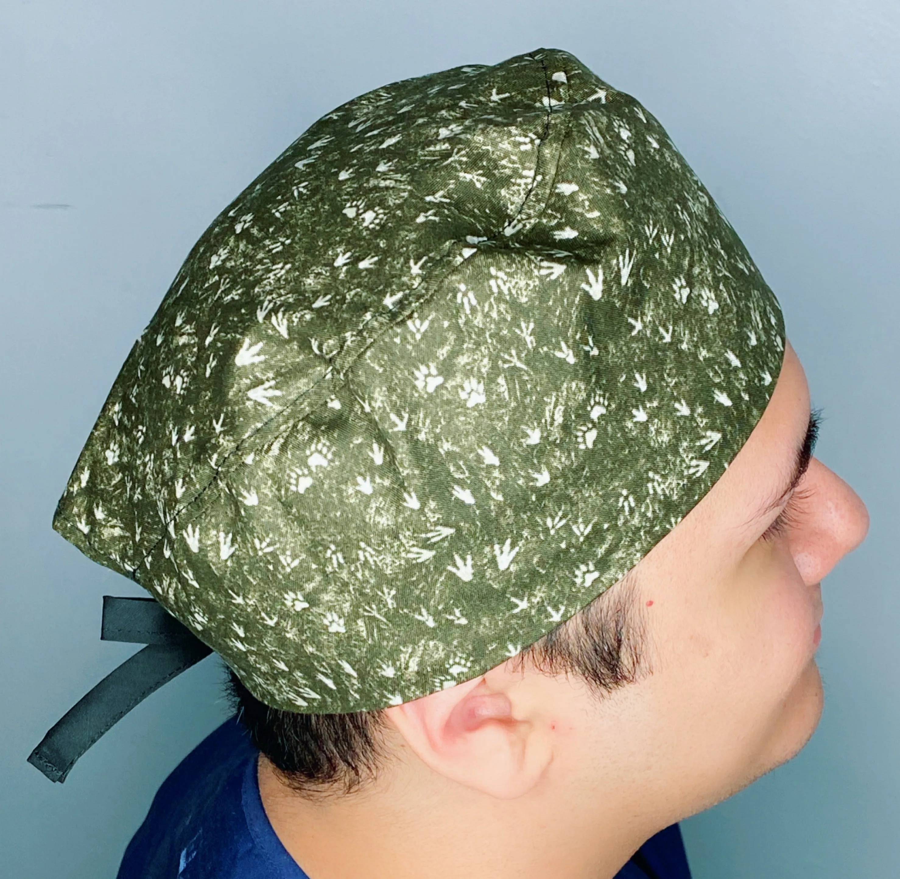 Dinosaurs Foot Prints on Hunter Green Unisex Animal Scrub Cap